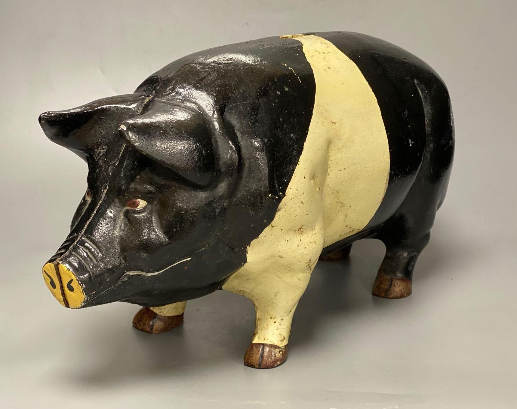 A large heavy cast iron saddle back pig money bank, circa 1950s, length 46cm